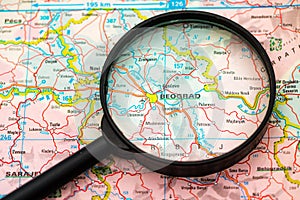 Map of Belgrade in Serbia through magnifying glass, travel destination concept