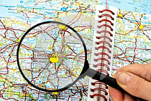 Map of Bruxelles in Belgium through magnifying glass, travel destination concept