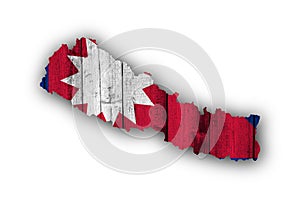 Map and flag of Nepal on weathered wood