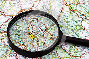 Map of Frankfurt in Germany through magnifying glass, travel destination concept