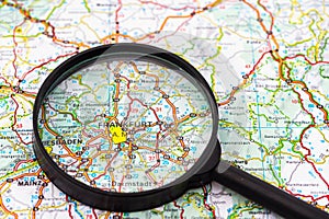 Map of Frankfurt in Germany through magnifying glass, travel destination concept