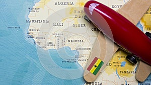 A map of Ghana and a red plane with a flag of Ghana attached to its wings.