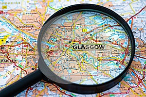 Map of Glasgow in Scotland through magnifying glass, travel destination concept