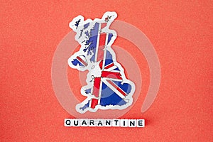 Map of Great Britain and word quarantine on a red background. Worldwide pandemic concept.