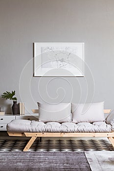map on grey wall in fashionable living room interior with scandinavian futon
