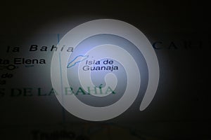 Ligth ilumination on a map a Honduras City Guanaja