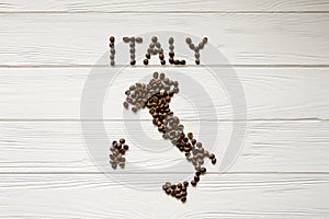 Map of the Italy made of roasted coffee beans laying on white wooden textured background