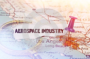 On a map of Los Angeles, next to a magnifying glass and paper with the inscription - aerospace industry