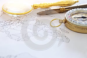 map, magnifying glass and old compass. selective focus. travel destination concept