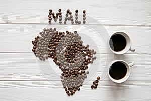 Map of the Mali made of roasted coffee beans laying on white wooden textured background with two cups of coffee