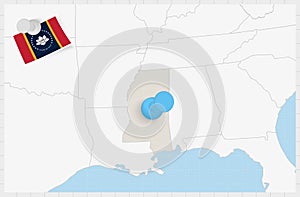 Map of Mississippi with a pinned blue pin. Pinned flag of Mississippi