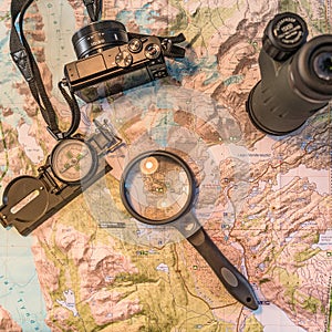 Map of Patagonia, compass, camera, monocular and loupe