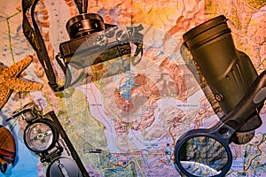 Map of Patagonia, compass, camera, monocular and loupe