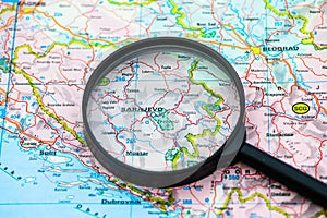 Map of Sarajevo in Bosnia-Herzevogina through magnifying glass, travel destination concept