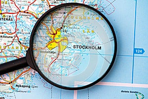Map of Stockholm in Sweden through magnifying glass, travel destination concept