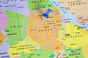 Map of Sudan with a pushpin stuck