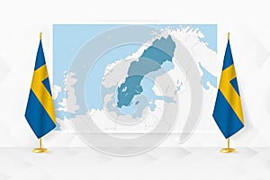 Map of Sweden and flags of Sweden on flag stand