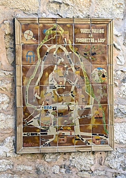 Map of Tourrettes on a stone wall in the `Violet village`, Tourrettes sur Loup in Provence, France