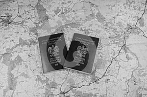Map and two passports ready to be used. Black and white photo.