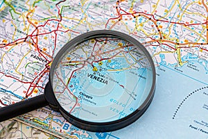 Map of Venice in Italy through magnifying glass, travel destination concept