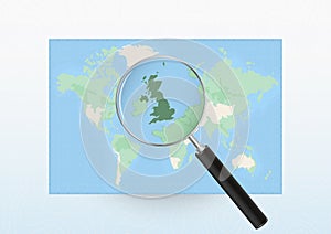 Map of the World with a magnifying glass aimed at United Kingdom, searching United Kingdom with loupe