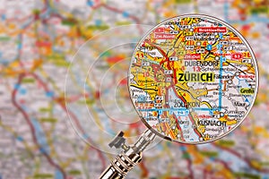 Map of Zurich with magnifying glass on table