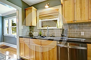 Maple kitchen cabinets with tile back splash trim