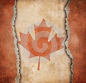 The Maple Leaf flag of Canada on torn paper