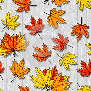 Maple leaves seamless pattern on gray wood background. Autumn foliage of deciduous tree lying on ligneous texture. Fall