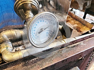 Maple syrup evaporator thermometer in maplehouse. Maple farming. Tools and equipment.