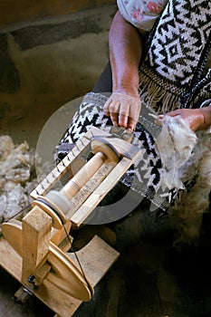 Mapuche woman hands works her handloom. photo