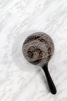 Maracas percussion instrument on marble background