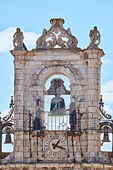 Maragato Colas and Maragata Colasa chiming the clock on top of the town hall of Astorga, Spain