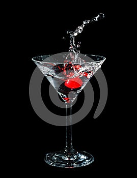 Maraschino cherry dropped in cocktail glass