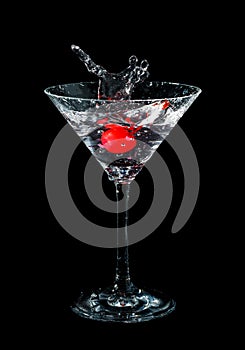 Maraschino cherry dropped in cocktail glass