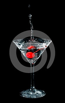 Maraschino cherry dropped in cocktail glass