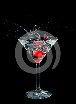 Maraschino cherry dropped in cocktail glass