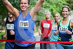 Marathon male athlete crossing the finish line