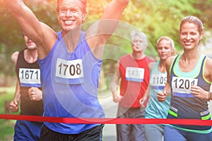 Marathon male athlete crossing the finish line