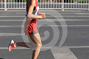 Marathon runner on city road photo