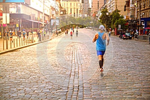 Marathon runners in the city and participate in the race.