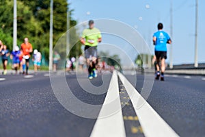 Marathon runners on city road