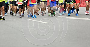 Marathon runners running on city road