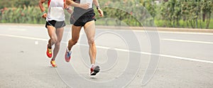 Marathon runners running on city road