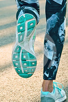 Marathon running in the morning light. Fitness outdoors healthy lifestlye. Beautiful sport woman legs in sportshoes