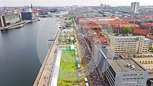 Marathon running race, aerial view of start and finish line with many runners from above, road racing, sport competition