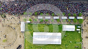 Marathon running race, aerial view of start and finish line with many runners from above, road racing, sport competition