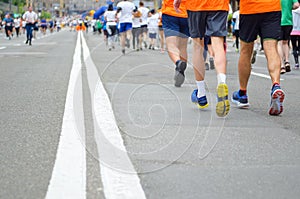 Marathon running race, many runners feet on road racing, sport competition, fitness and healthy lifestyle