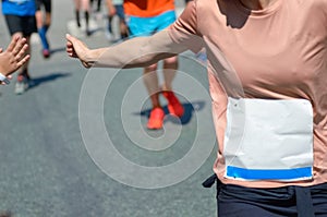 Marathon running race,runners support on road race, child`s hand giving highfive, kid supporting athletes who run
