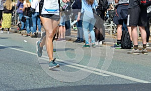 Marathon running race, woman runner feet on road racing, sport competition, fitness and healthy lifestyle
